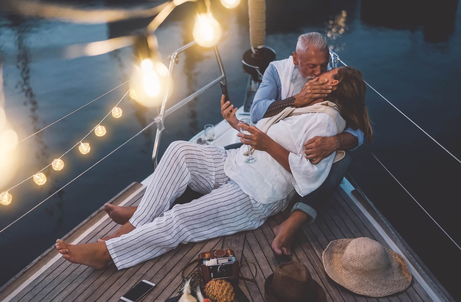 Senior couple kissing during sailboat vacation